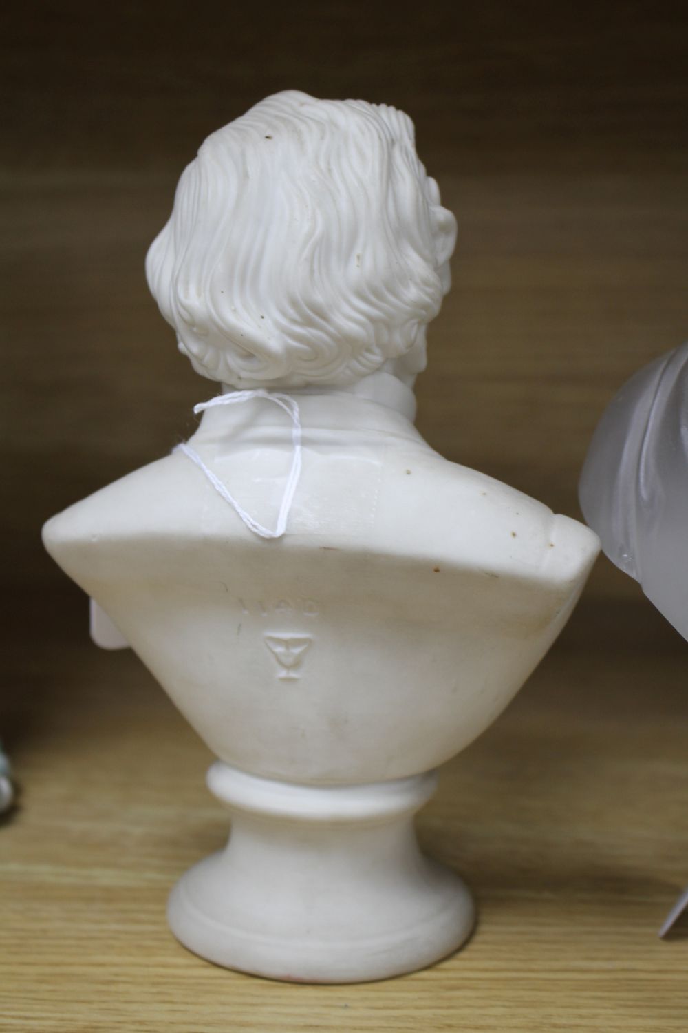A glass bust of Prince Albert by F & C Osler, inscribed to base, 26cm and a parian bust of Disraeli (2)